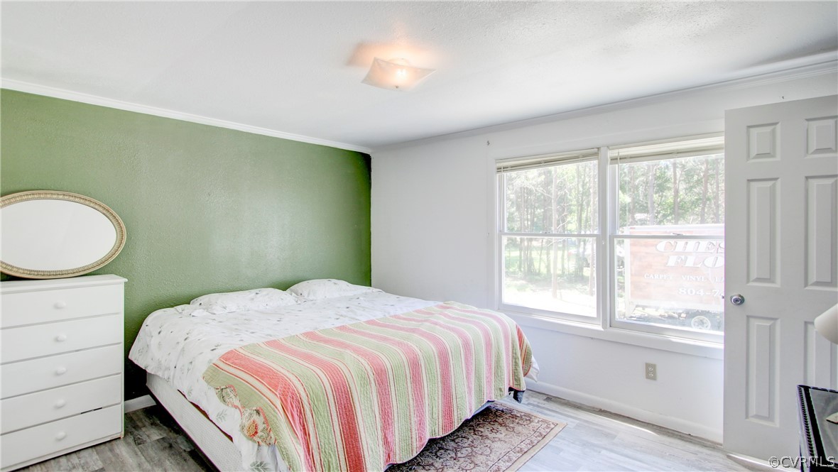 1694 Rolling Acres Road Emporia, VA 23847 - Photo 26 of 45 Bedroom featuring crown molding and light wood-typ