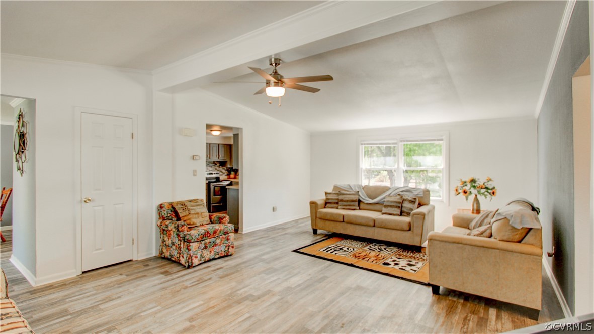Living room with vaulted ceiling with beams, ceili