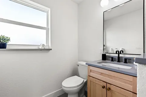 a living room with furniture a flat screen tv and rug