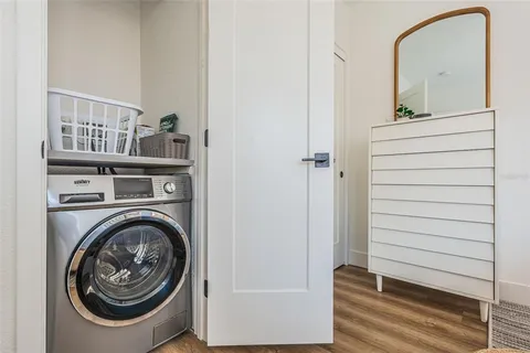 a living room with furniture a rug and a flat screen tv