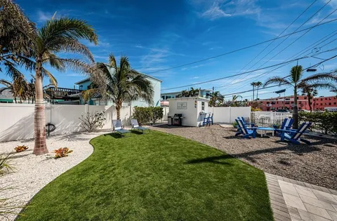 a view of a house with backyard porch and sitting area