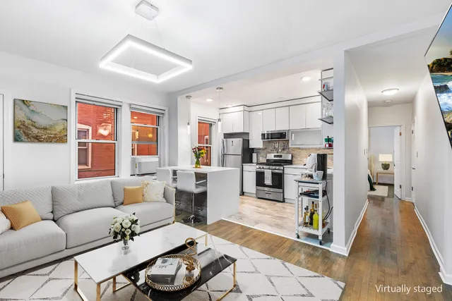 a living room with furniture kitchen and a table
