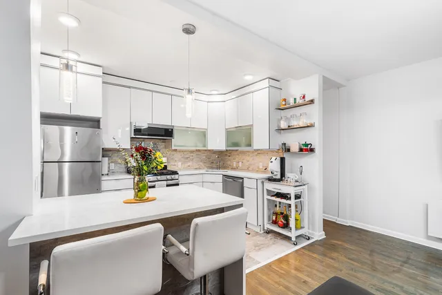 a kitchen with a sink appliances and cabinets
