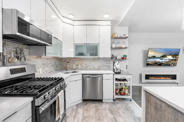 a kitchen with stainless steel appliances granite countertop a stove and a sink