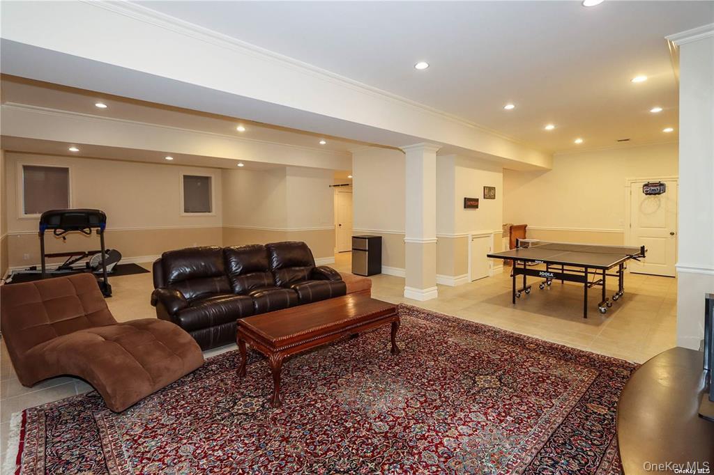 24 Steamboat Road Great Neck, NY 11024 - Photo 26 of 28 Living room featuring ornamental molding, recessed lighting, and light tile patterned floors