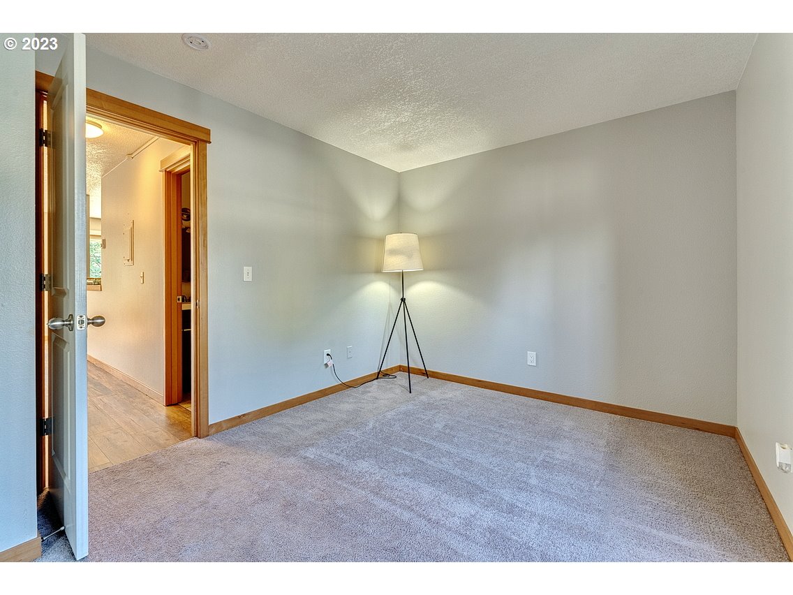200 Southwest Florence Avenue, Unit C9 Gresham, OR 97080 - Photo 20 of 32 a view of an empty room with wooden floor and a window