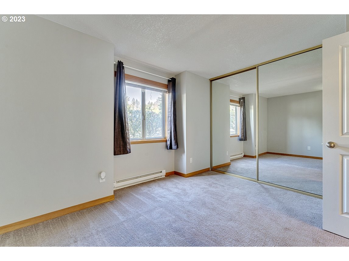 200 Southwest Florence Avenue, Unit C9 Gresham, OR 97080 - Photo 21 of 32 a view of an empty room with window and wooden floor