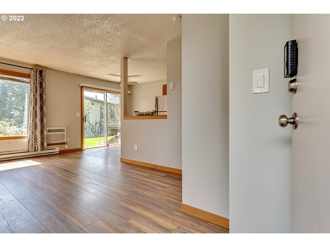 200 Southwest Florence Avenue, Unit C9 Gresham, OR 97080 - Photo 4 of 32 a empty room with wooden floor and windows