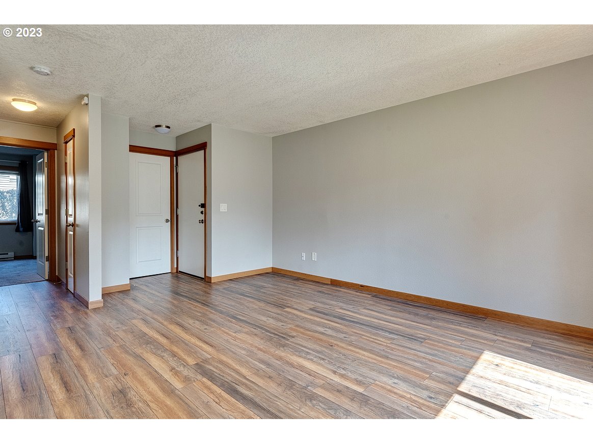 200 Southwest Florence Avenue, Unit C9 Gresham, OR 97080 - Photo 7 of 32 a view of an empty room and wooden floor