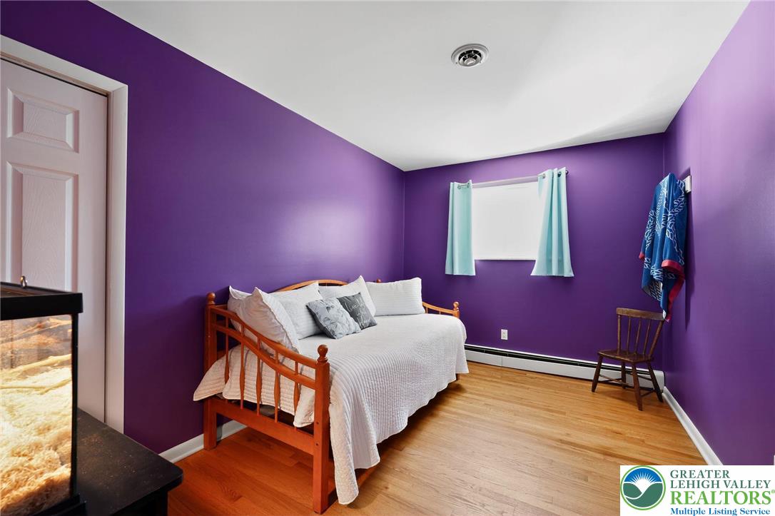 3541 Lumar Street Orefield, PA 18069 - Photo 21 of 30 a bedroom with a bed and wooden floor