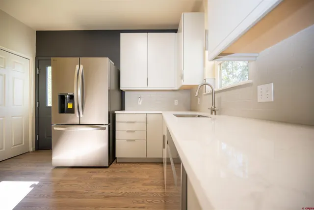 a kitchen with a refrigerator a stove a sink and a dishwasher
