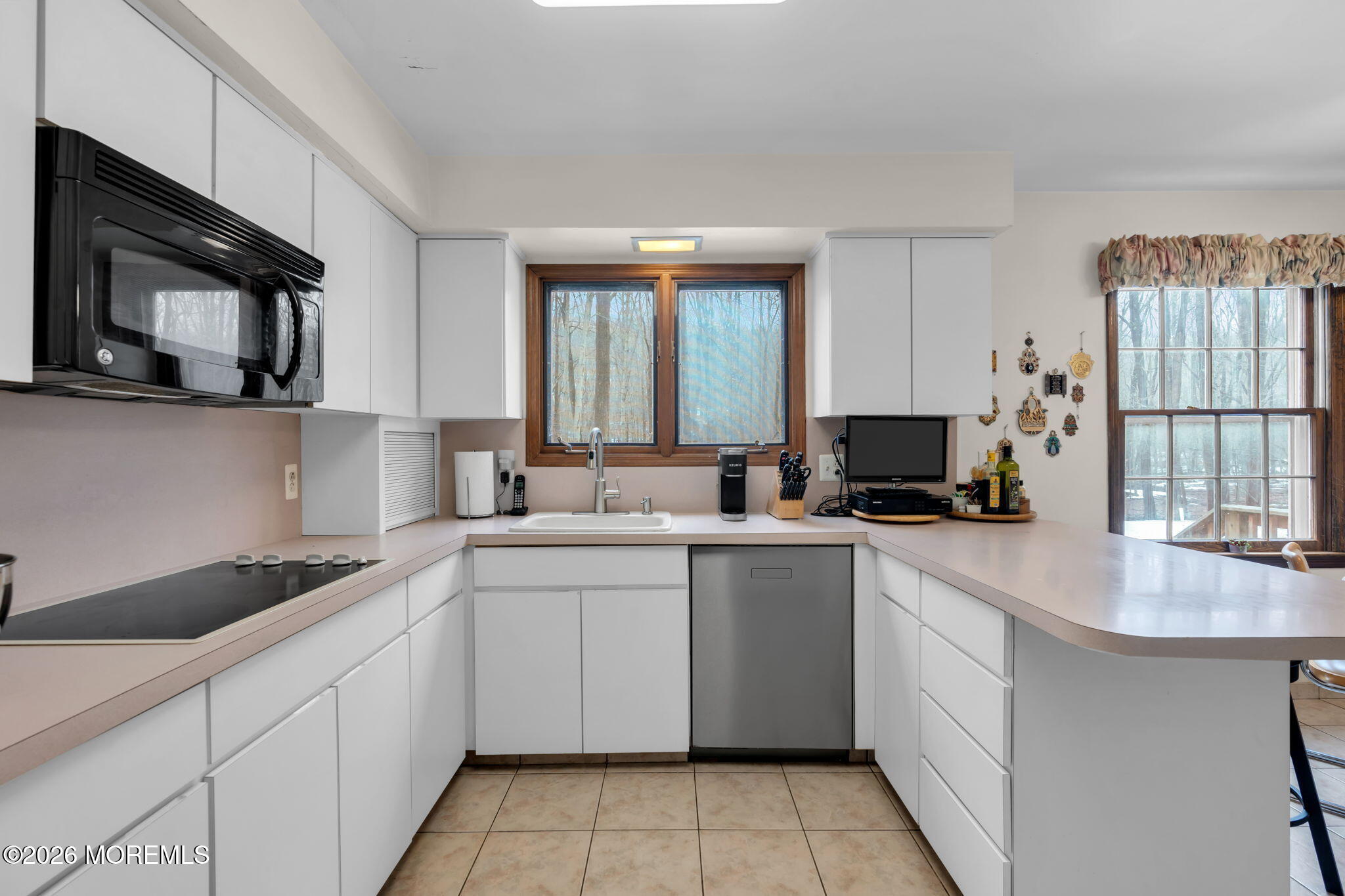 103 Reids Hill Road Morganville, NJ 07751 - Photo 17 of 44 a kitchen with a sink stove and cabinets