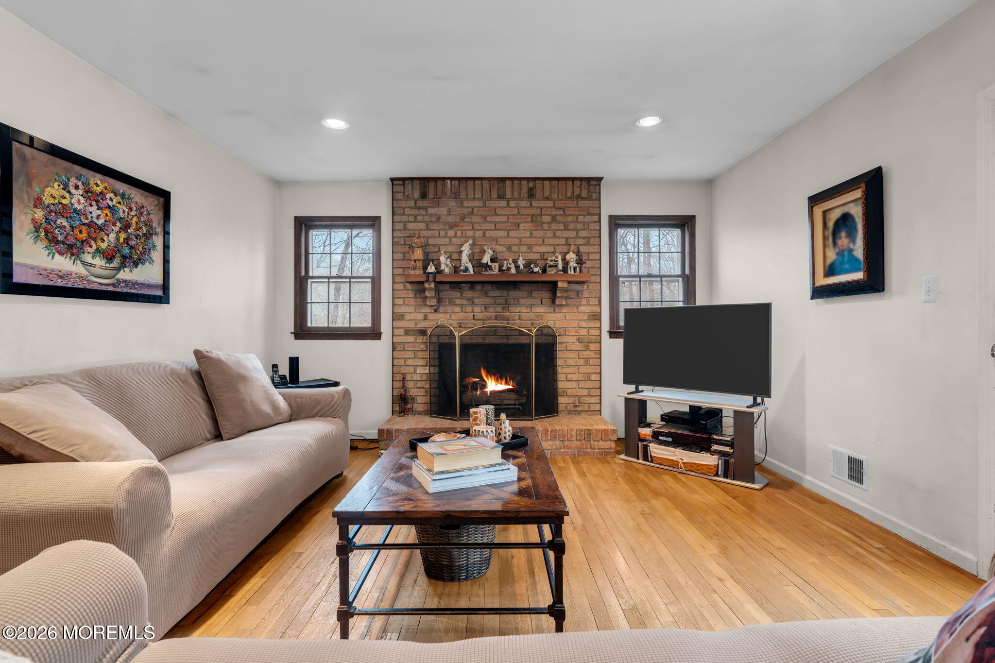 103 Reids Hill Road Morganville, NJ 07751 - Photo 25 of 44 a living room with furniture a fireplace and a flat screen tv
