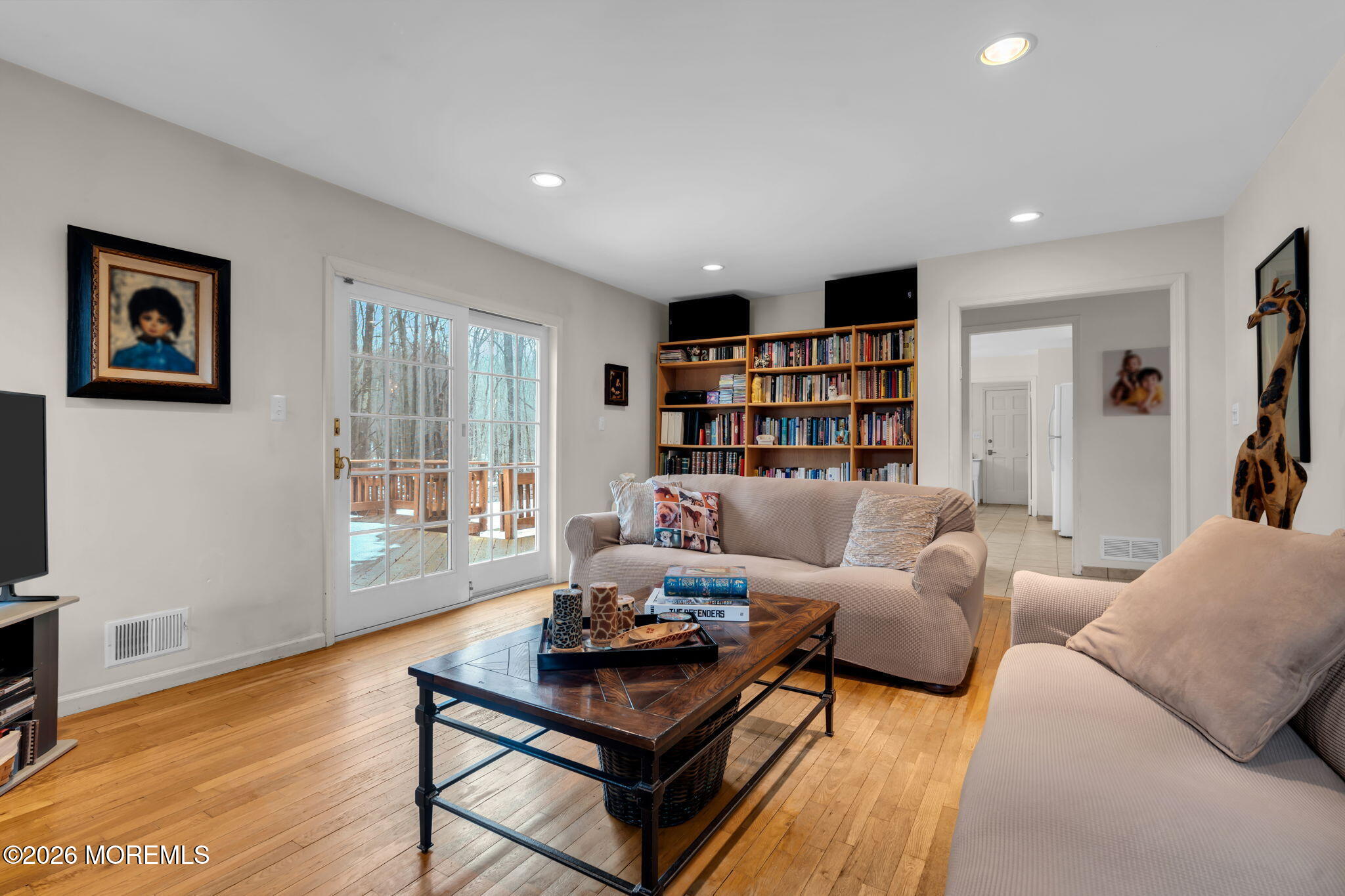103 Reids Hill Road Morganville, NJ 07751 - Photo 26 of 44 a living room with furniture and a book shelf