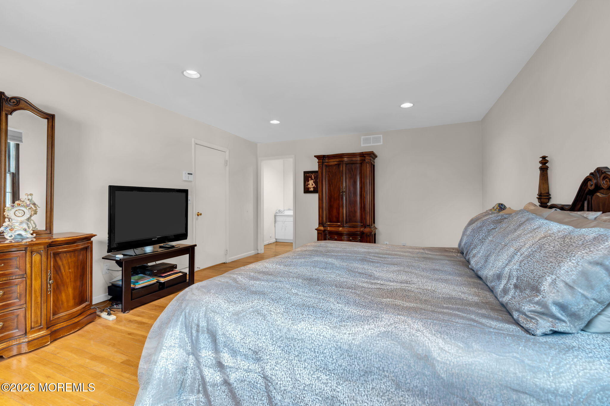 103 Reids Hill Road Morganville, NJ 07751 - Photo 34 of 44 a bedroom with a bed and a flat screen tv