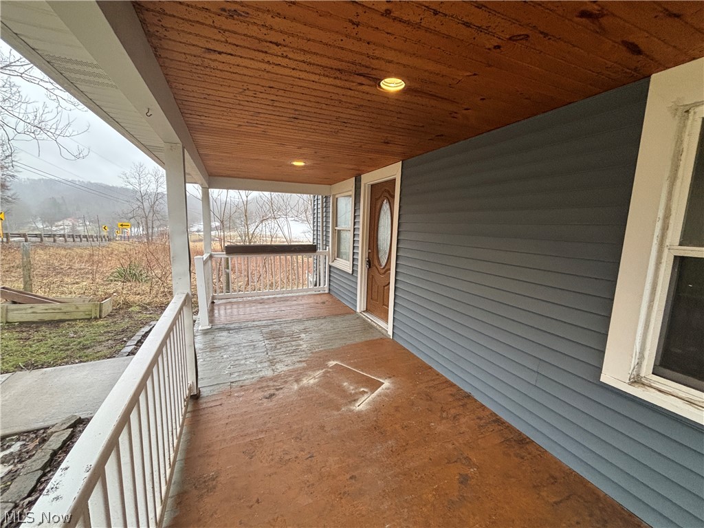 4301 Steubenville Road Southeast Amsterdam, OH 43903 - Photo 3 of 27 Front porch, wood ceiling