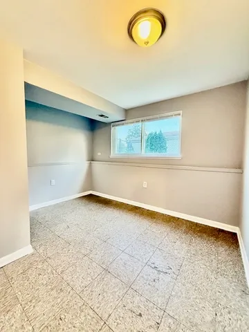 an empty room with a empty space and a window