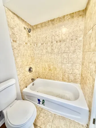 a bathroom with a bathtub and toilet