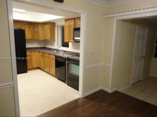 a kitchen with a refrigerator and a sink