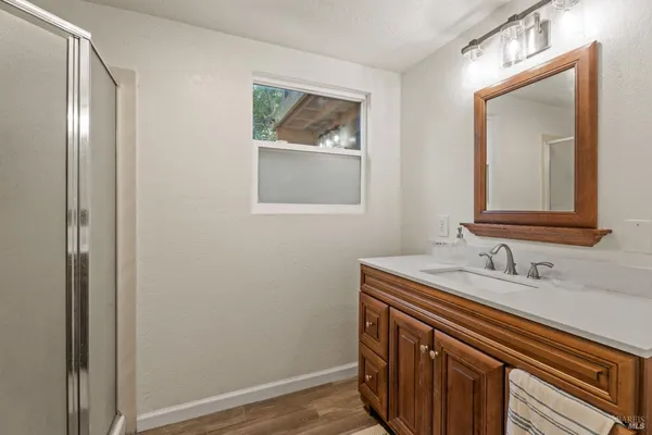a bathroom with a sink a vanity and a mirror
