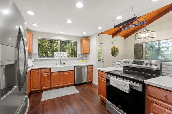 a kitchen with stainless steel appliances granite countertop a stove and a sink