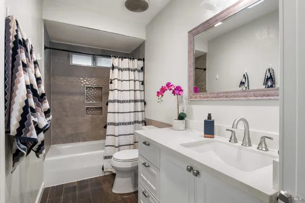 a bathroom with a sink toilet and shower