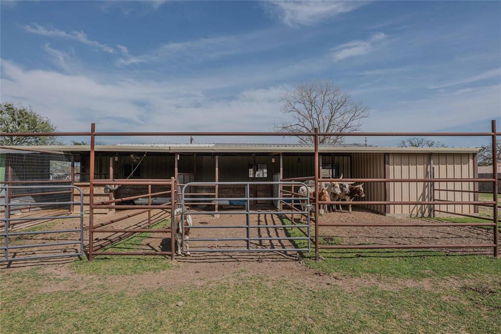 900 Silver Creek Azle Road Azle, TX 76020 - Photo 20 of 27 Barn structure with a corrugated metal roof and a tan metal siding exterior