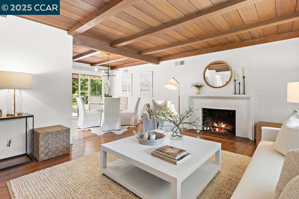 a living room with furniture a fireplace and a table