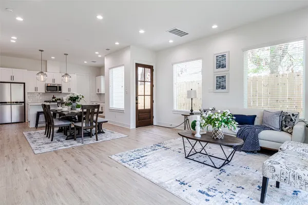 a living room with furniture and wooden floor