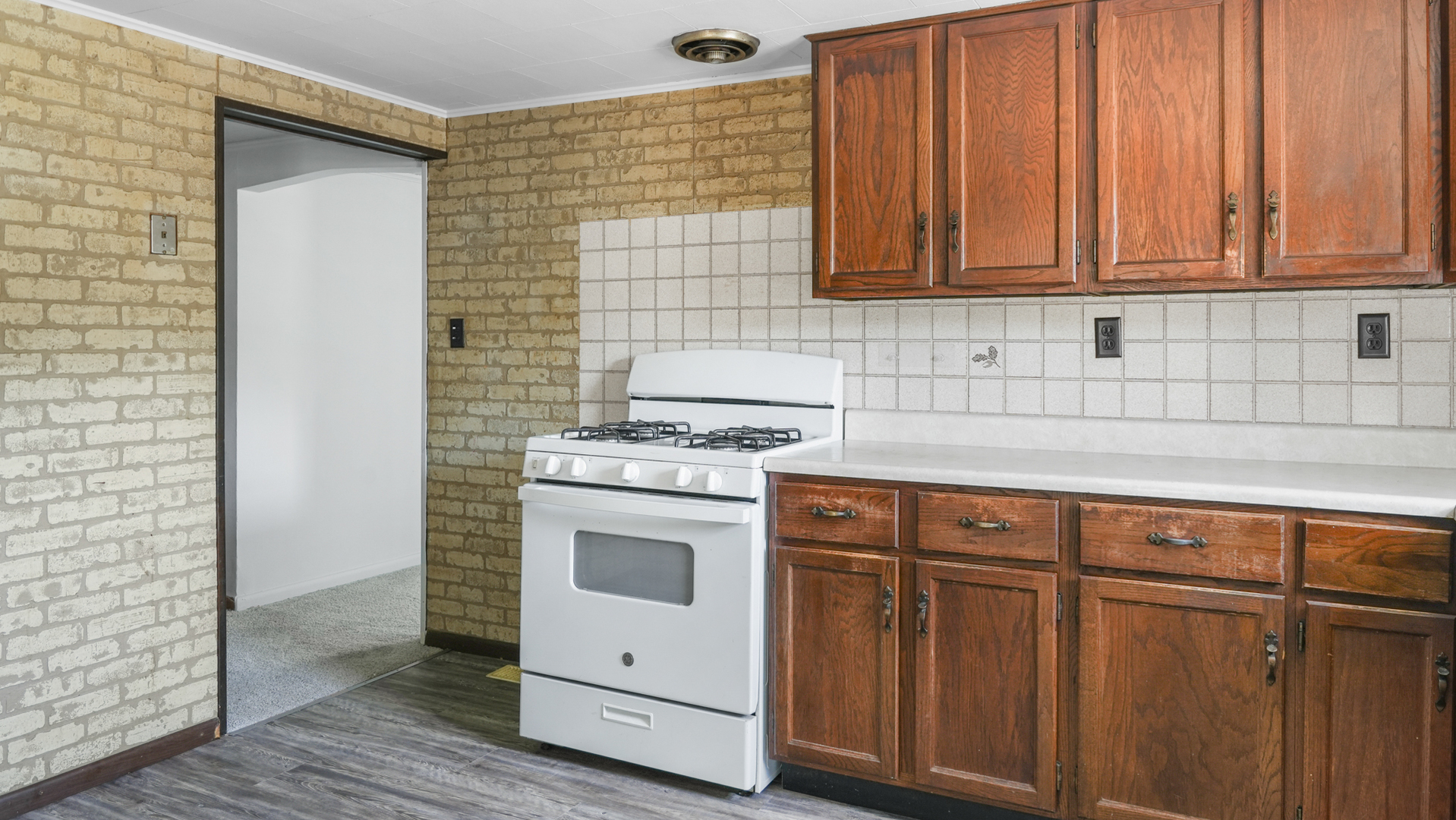 913 Forrest Street Danville, IL 61832 - Photo 9 of 29 a stove top oven sitting inside of a kitchen