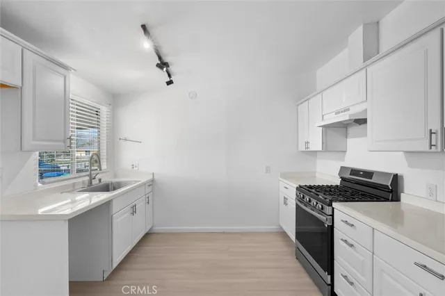 a kitchen that has a sink and a stove