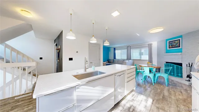 a large white kitchen with a table and chairs