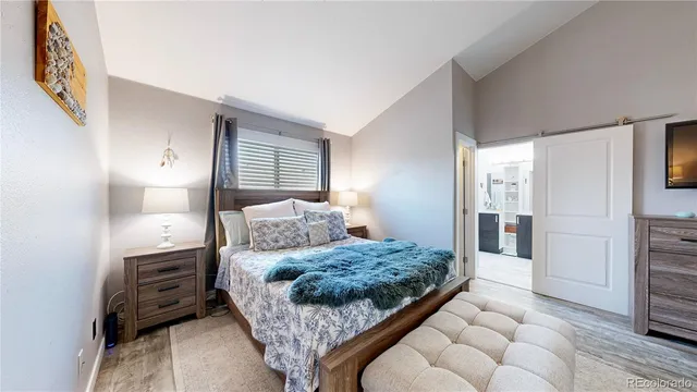 a bedroom with a bed and a couch