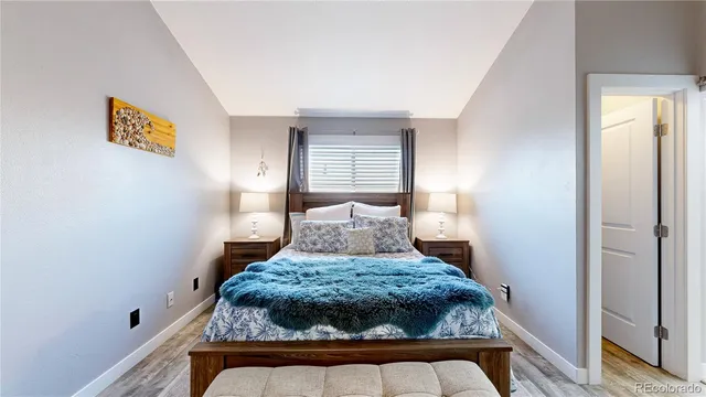 a bed sitting in a bedroom next to a window