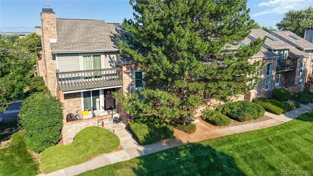 a aerial view of a house with a yard table and chairs