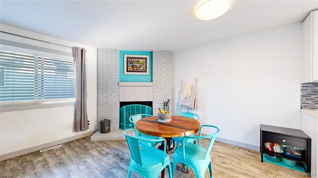 a view of a dining room with furniture and a fireplace