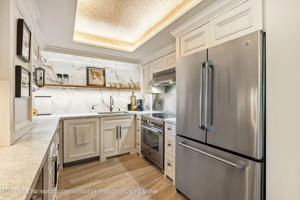 a kitchen with stainless steel appliances granite countertop a refrigerator and a sink