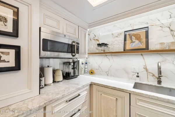 a kitchen with a sink stainless steel appliances and cabinets