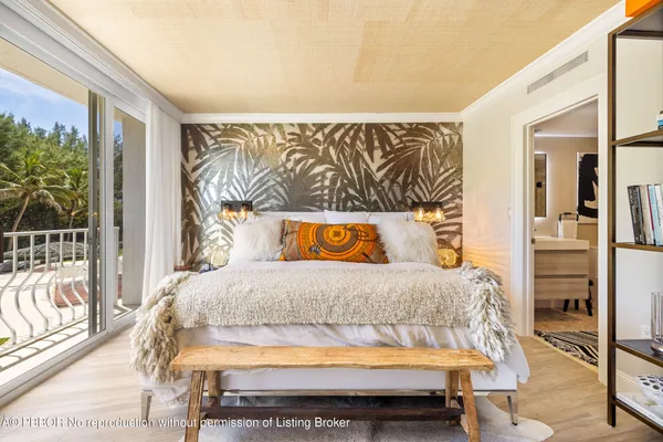 a bedroom with a bed and painting on the wall