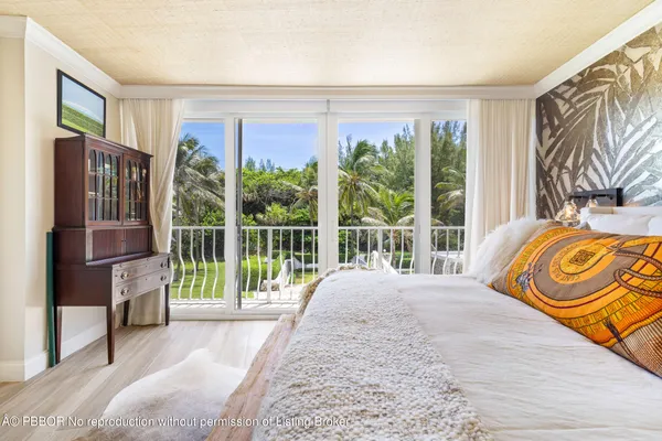 a view of a bedroom with a bed and glass door