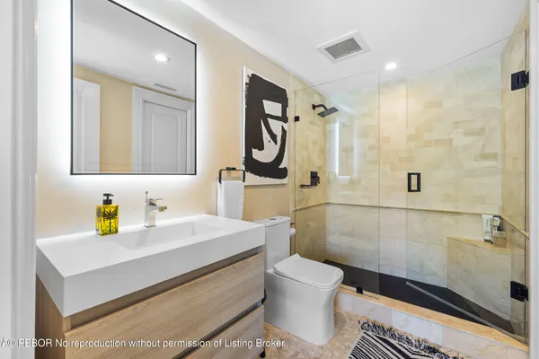 a bathroom with a sink a toilet and shower