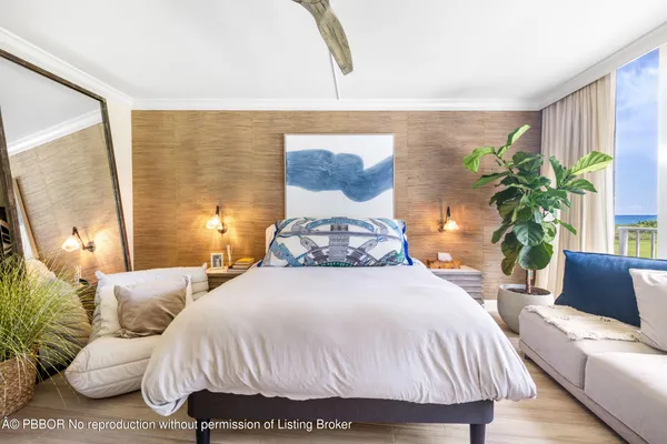 a bedroom with a bed and a potted plant