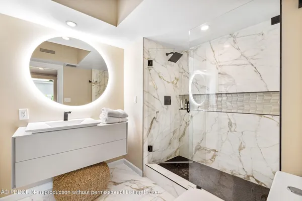 a bathroom with a sink mirror and vanity
