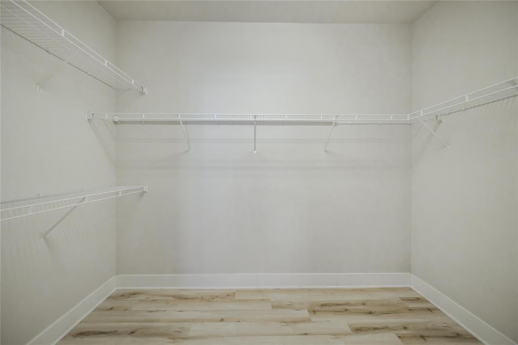 4414 Cedar Springs Road, Unit 214 Dallas, TX 75219 - Photo 21 of 29 Walk in closet featuring light wood finished floors