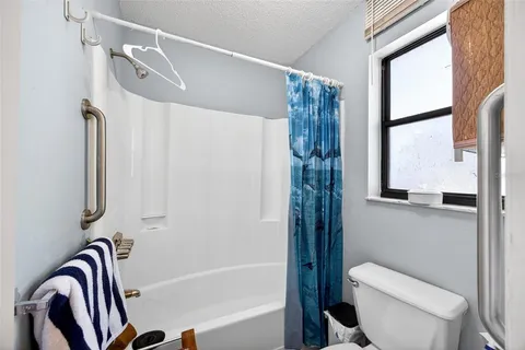 a bathroom with a shower and a toilet