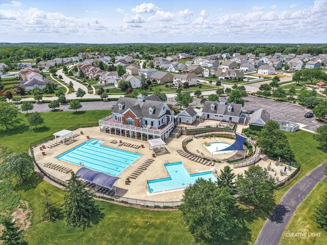 an aerial view of a city with lots of residential buildings lake and ocean view