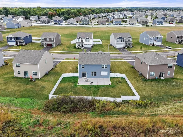 a view of a house with a yard and a lake view
