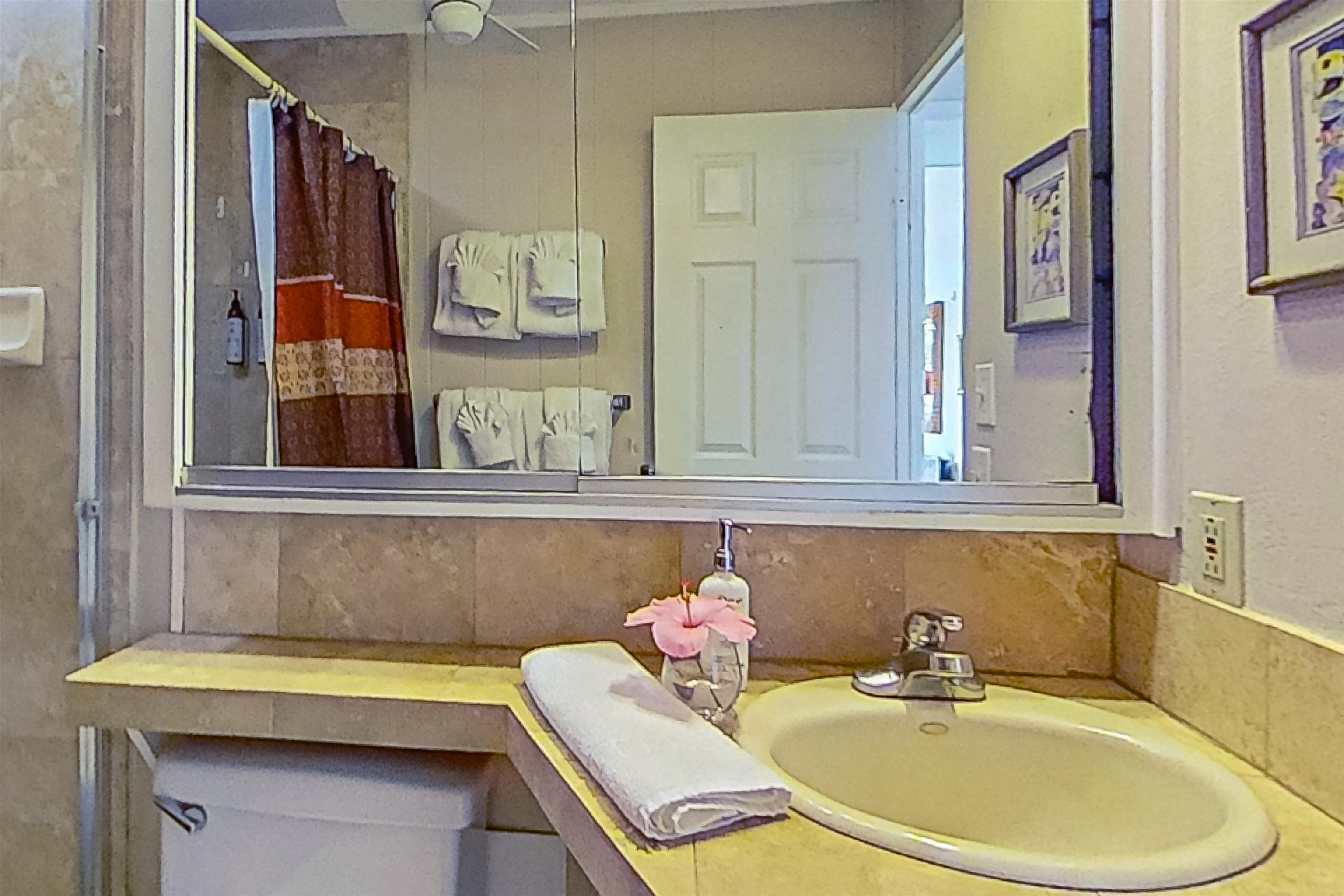 4057 Lower Honoapiilani Road, Unit 116 Lahaina, HI 96761 - Photo 16 of 38 a bathroom with a sink and a mirror