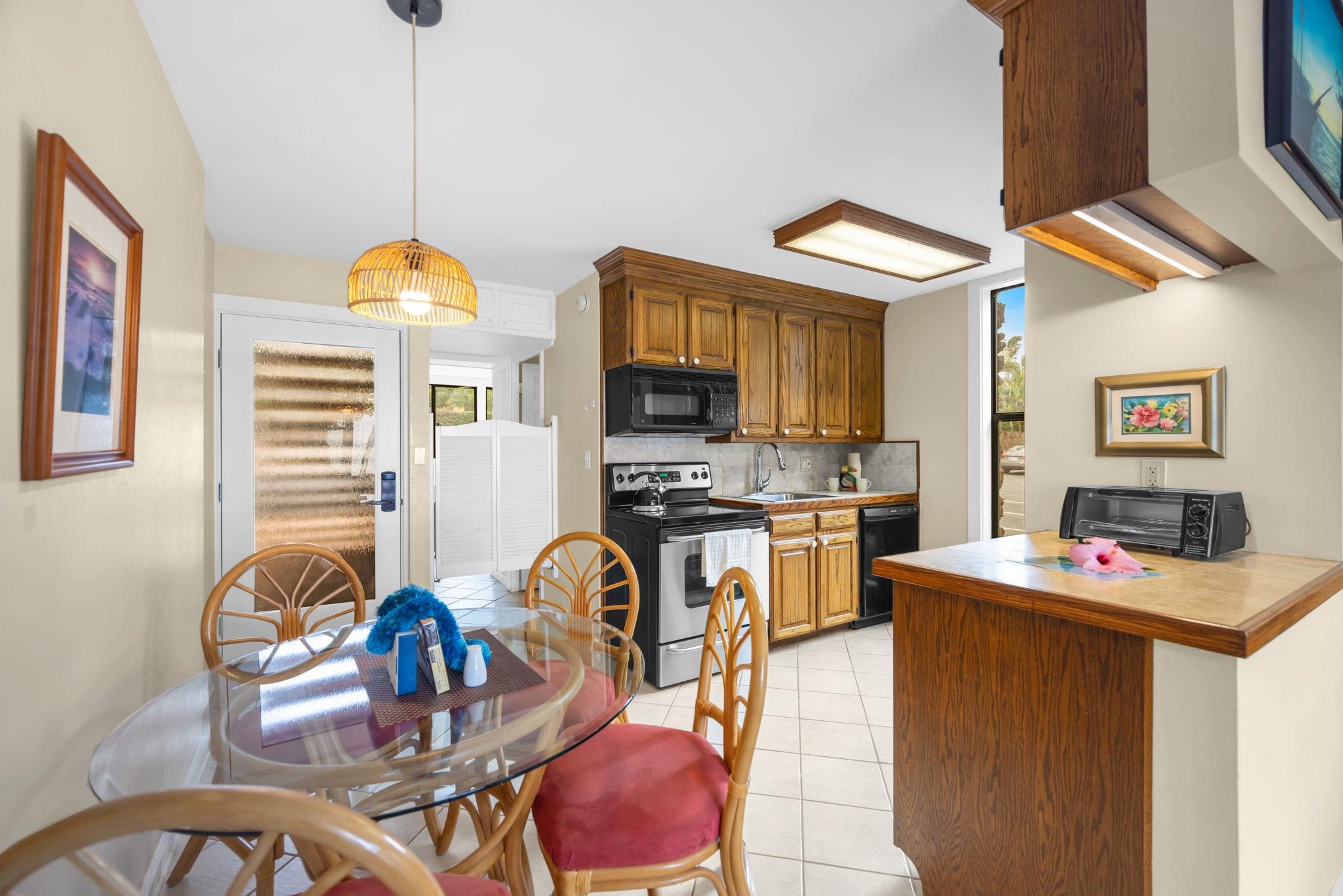 4057 Lower Honoapiilani Road, Unit 116 Lahaina, HI 96761 - Photo 18 of 38 a view of a kitchen and dining room
