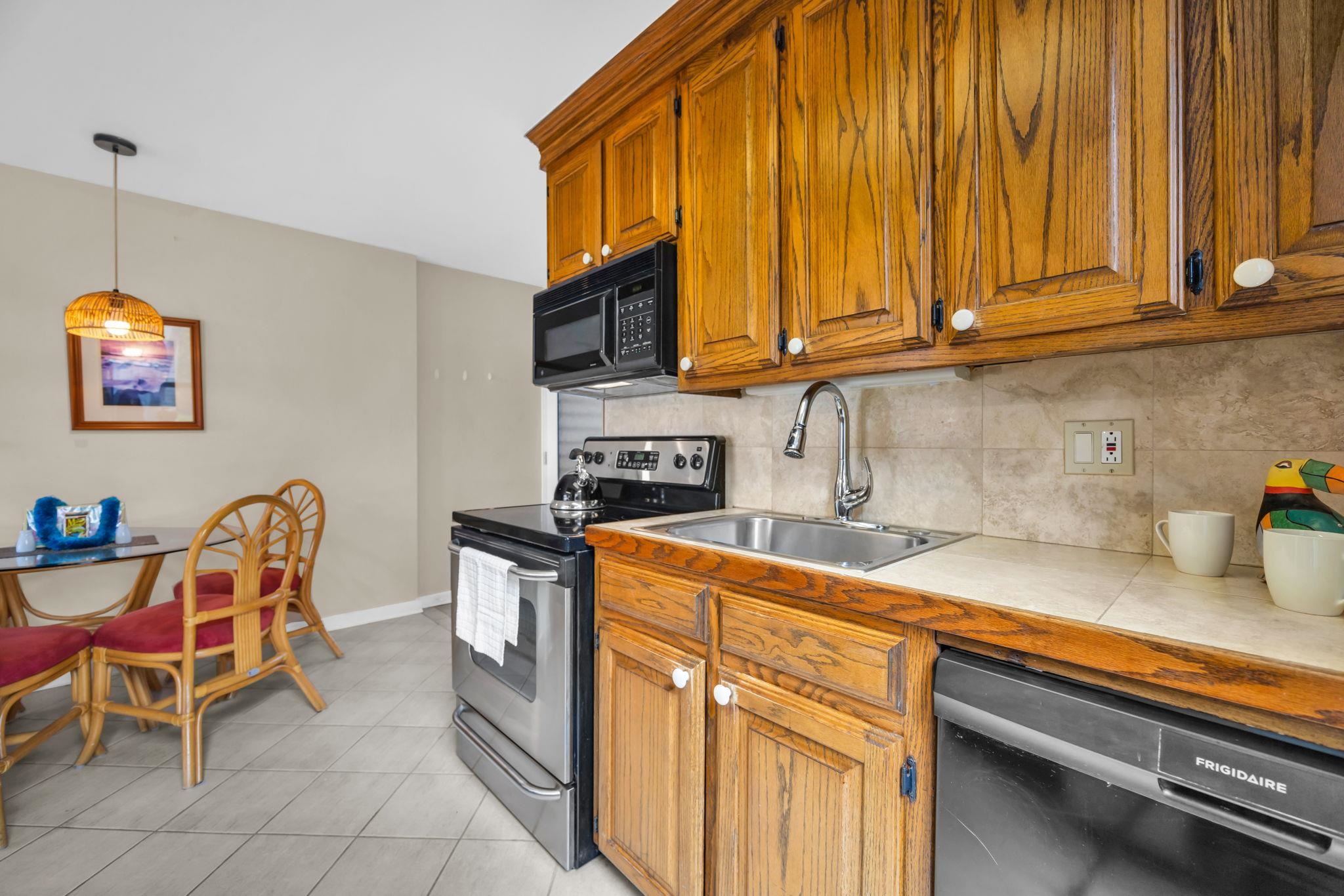 4057 Lower Honoapiilani Road, Unit 116 Lahaina, HI 96761 - Photo 19 of 38 a kitchen with stainless steel appliances granite countertop a sink and cabinets